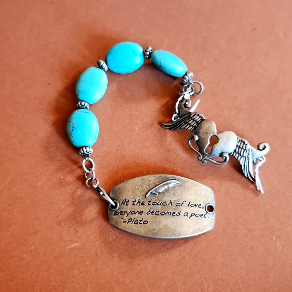 Turquoise stone with two pendants silver tone.